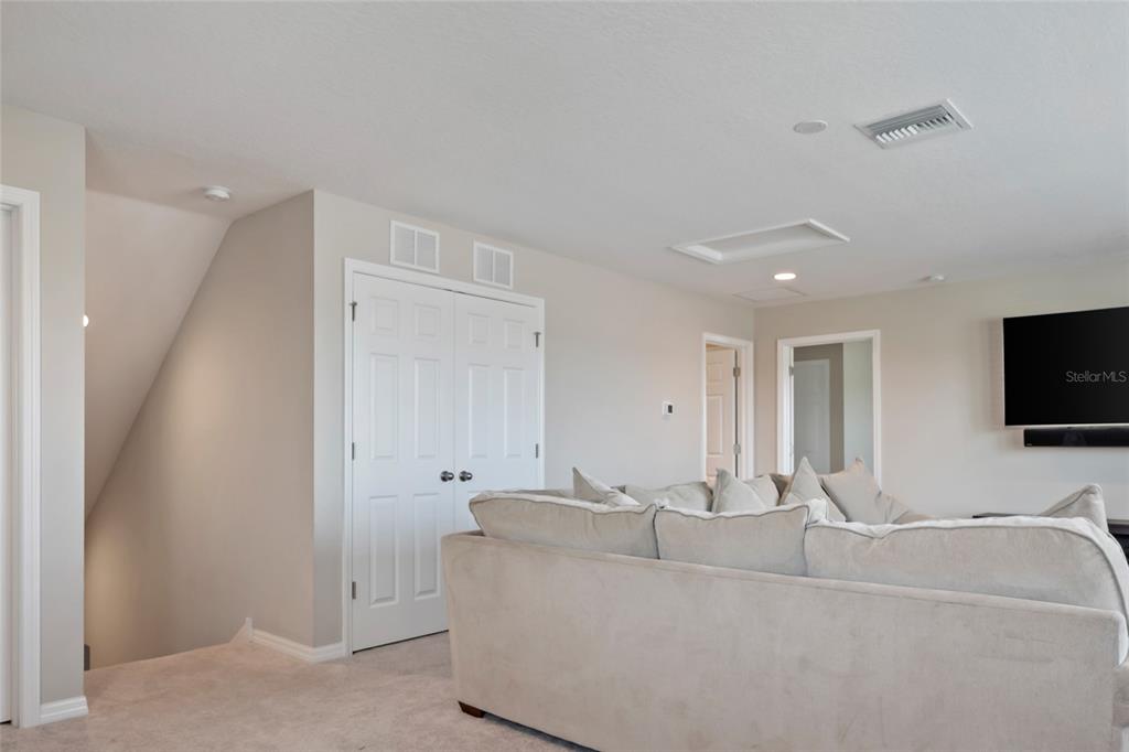 18428 Malinche Loop Spring Hill, FL 34610 - Photo 27 of 62 a living room with furniture and a flat screen tv