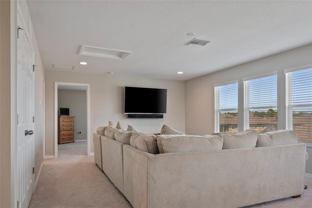 18428 Malinche Loop Spring Hill, FL 34610 - Photo 29 of 62 a living room with furniture and a flat screen tv