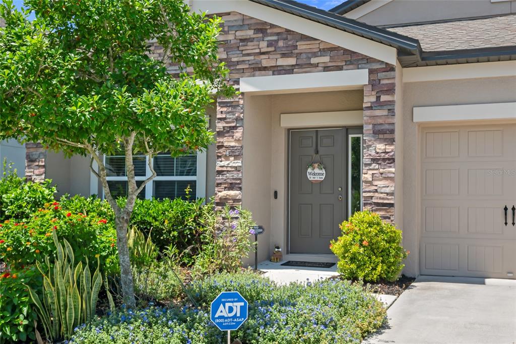 18428 Malinche Loop Spring Hill, FL 34610 - Photo 3 of 62 a front view of a house with garden