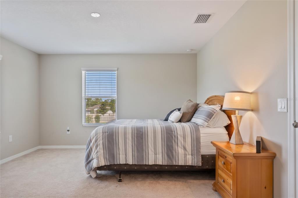18428 Malinche Loop Spring Hill, FL 34610 - Photo 32 of 62 a bedroom with a bed and a window