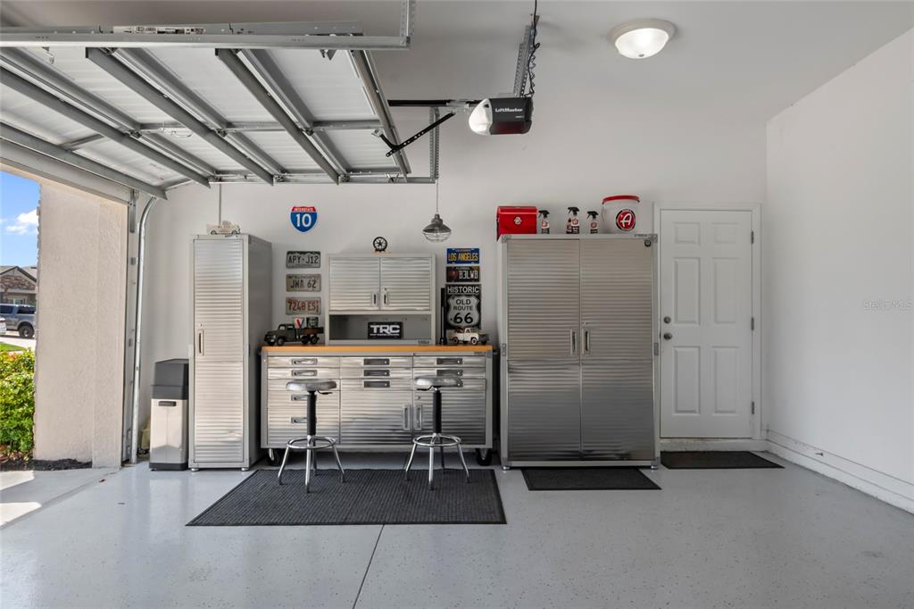 18428 Malinche Loop Spring Hill, FL 34610 - Photo 36 of 62 a room with stainless steel appliances kitchen island granite countertop a refrigerator and a stove