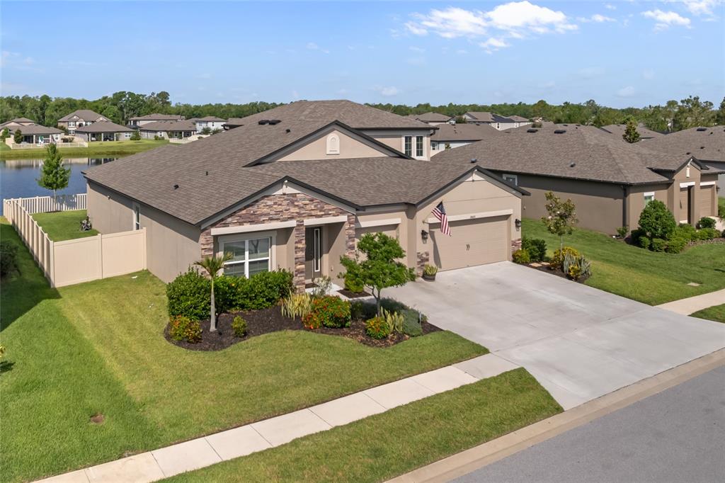 18428 Malinche Loop Spring Hill, FL 34610 - Photo 39 of 62 a aerial view of a house with a garden and plants