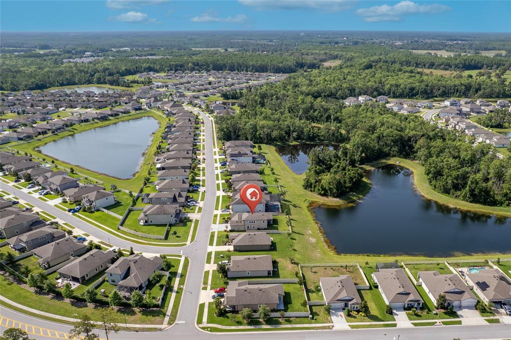 18428 Malinche Loop Spring Hill, FL 34610 - Photo 48 of 62 an aerial view of residential houses with outdoor space and lake view