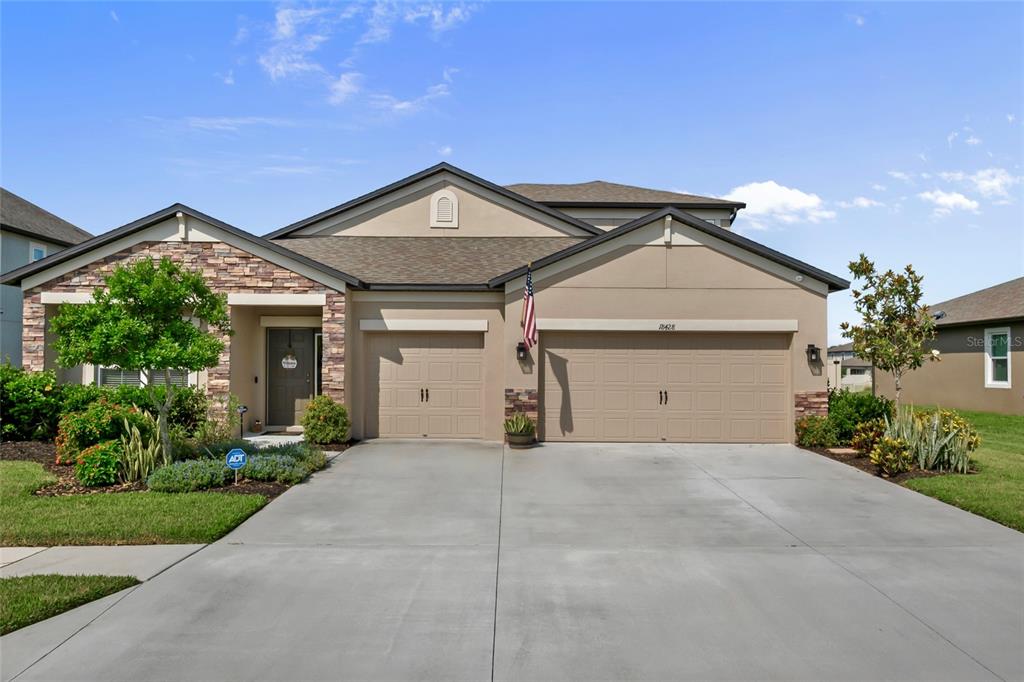 18428 Malinche Loop Spring Hill, FL 34610 - Photo 49 of 62 a front view of a house with a yard and garage