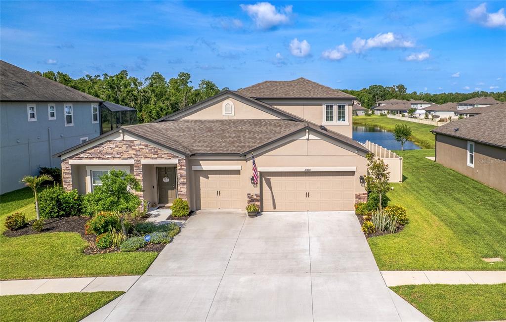 18428 Malinche Loop Spring Hill, FL 34610 - Photo 5 of 62 a front view of a house with a yard