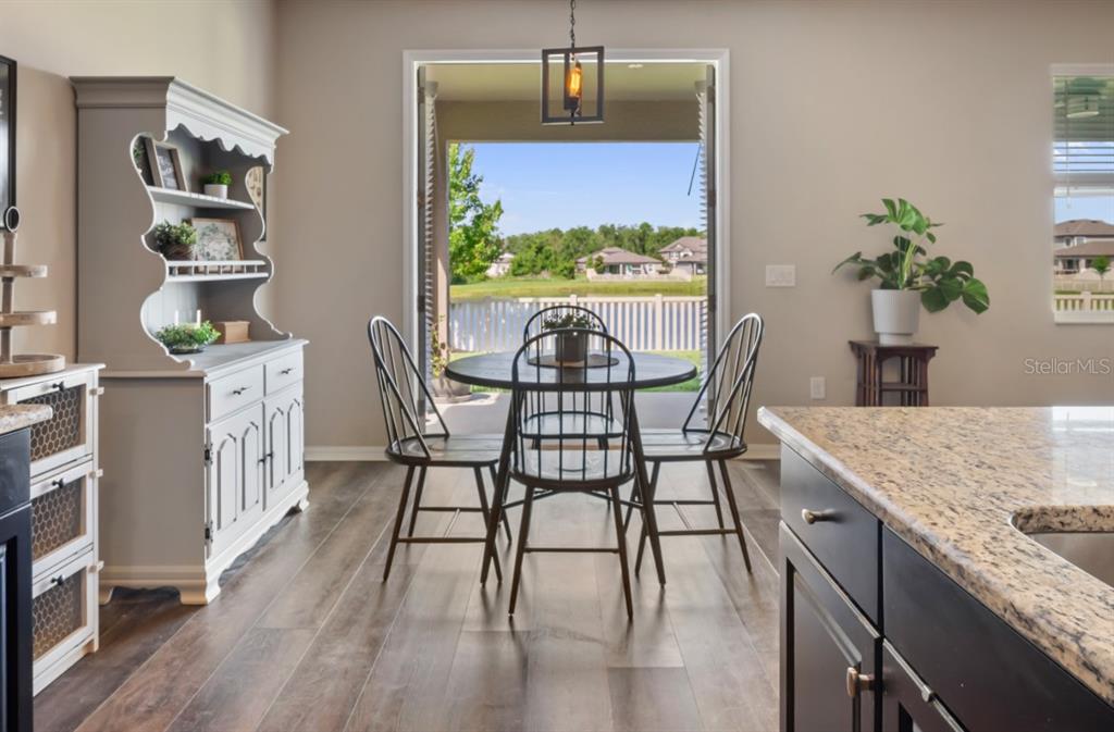 18428 Malinche Loop Spring Hill, FL 34610 - Photo 7 of 62 a dining room with furniture and wooden floor