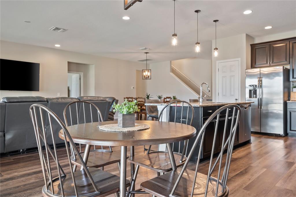 18428 Malinche Loop Spring Hill, FL 34610 - Photo 9 of 62 a view of a dining room with furniture and wooden floor