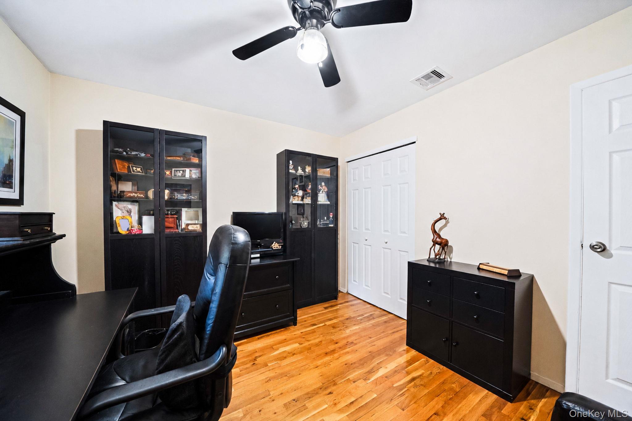 96 Fulton Boulevard Commack, NY 11725 - Photo 33 of 41 a bed room with a bed and a desk