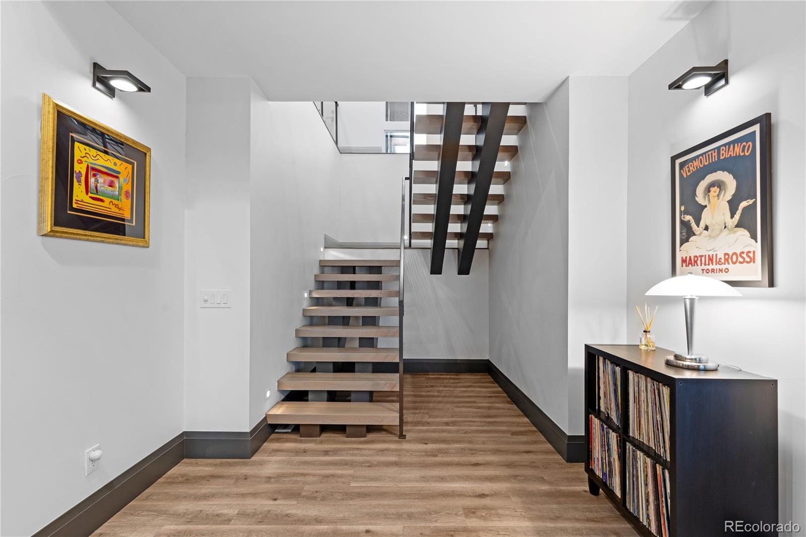 10689 Shadow Pines Road Parker, CO 80138 - Photo 37 of 50 a view of a hallway with wooden floor and workspace