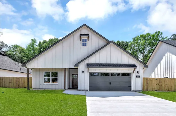 a view of a house with a yard and potted plants
