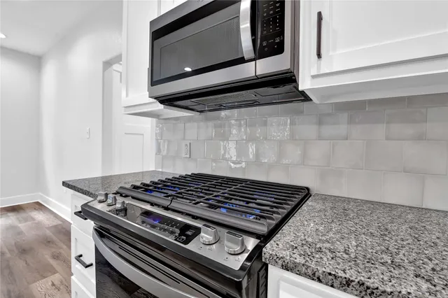 a stove top oven sitting inside of a kitchen
