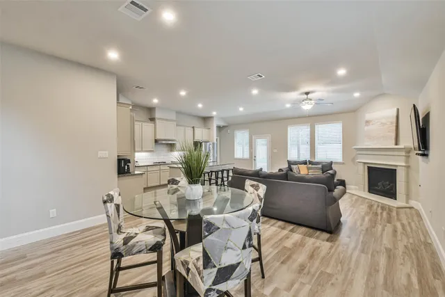 a view of a dining room with furniture fireplace and wooden floor
