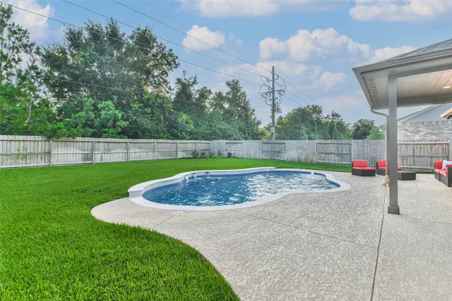 a view of a house with a yard and sitting area