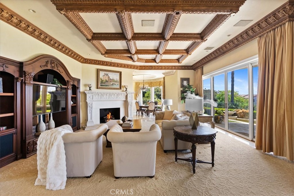 60 Ritz Cove Drive Dana Point, CA 92629 - Photo 12 of 74 Large Family Room with cozy fireplace, built-in entertainment center, oversized sliding doors that lead to your patio, pool and OCEAN VIEWS!
