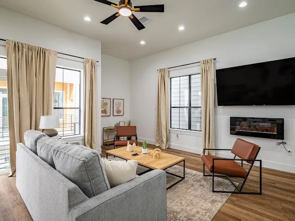 a living room with fireplace furniture and a flat screen tv
