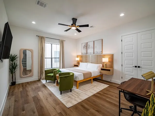 a bedroom with a bed and a flat screen tv