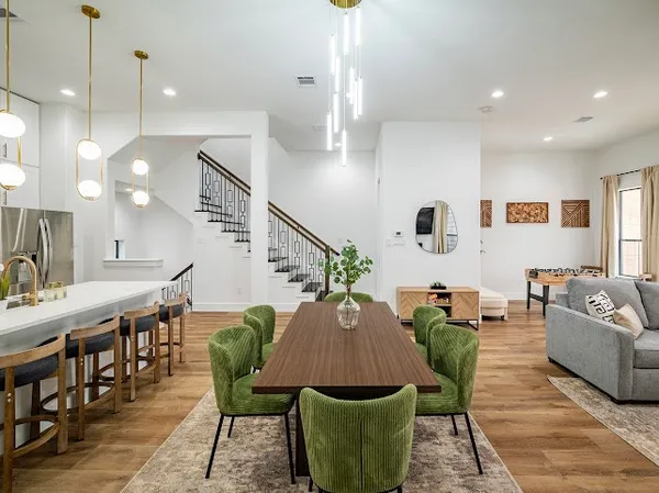 a living room with furniture a rug and a chandelier