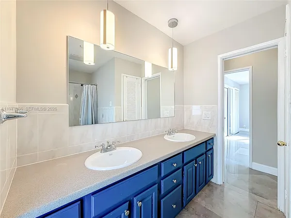 a bathroom with a double vanity sink and a mirror