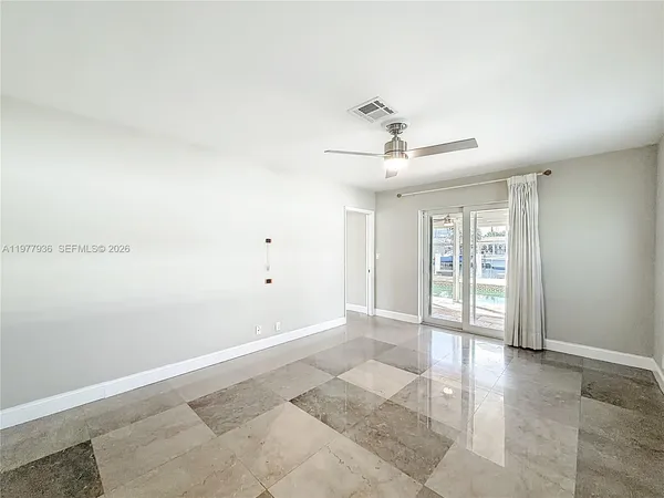 a view of a livingroom with furniture and a ceiling fan