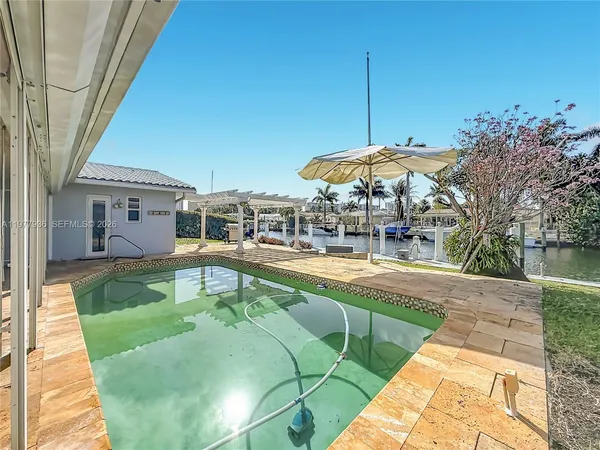 a front view of a house with a yard and potted plants