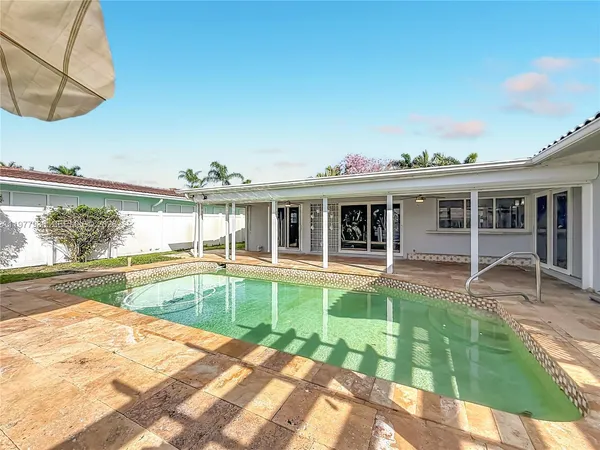 a view of a kitchen with refrigerator and cabinets