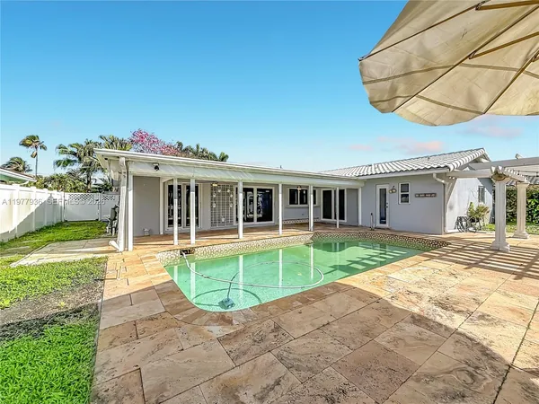 a view of a porch with a table and chairs
