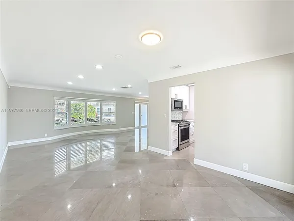 a kitchen with cabinets stainless steel appliances and a counter space