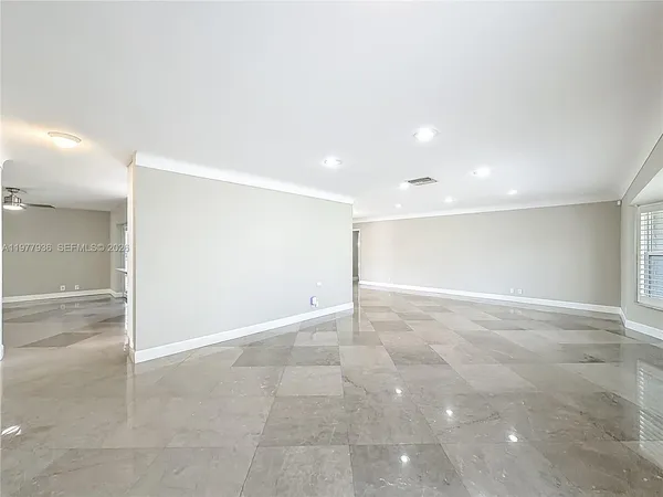 a kitchen with granite countertop white cabinets and stainless steel appliances