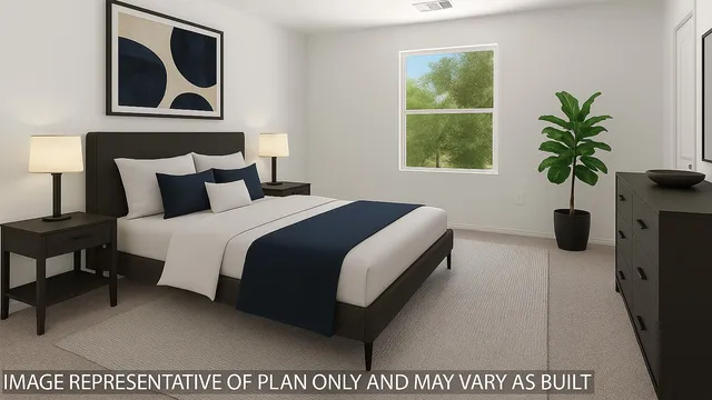 a bedroom with a bed and a potted plant