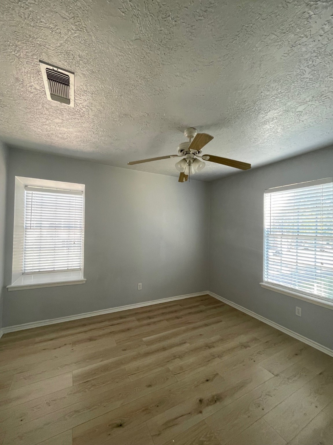 9250 Beechnut Street, Unit 21 Houston, TX 77036 - Photo 13 of 18 a view of empty room with wooden floor and fan