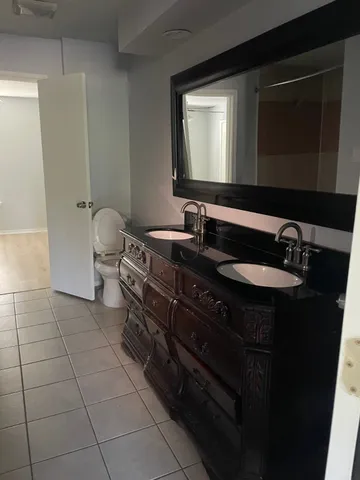 a bathroom with a double vanity sink and a mirror