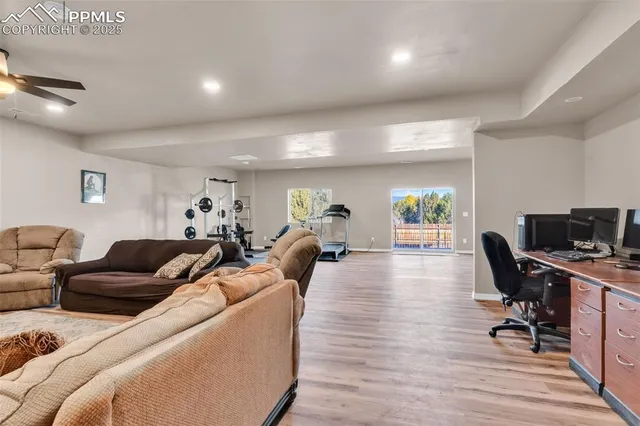 a living room with furniture a wooden floor and a flat screen tv