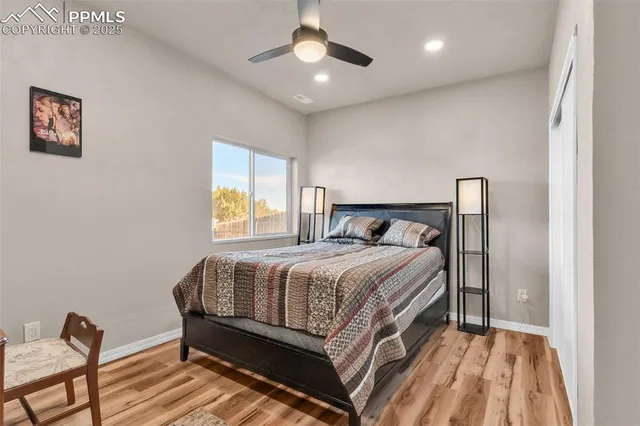 a bed sitting in a bedroom next to a window