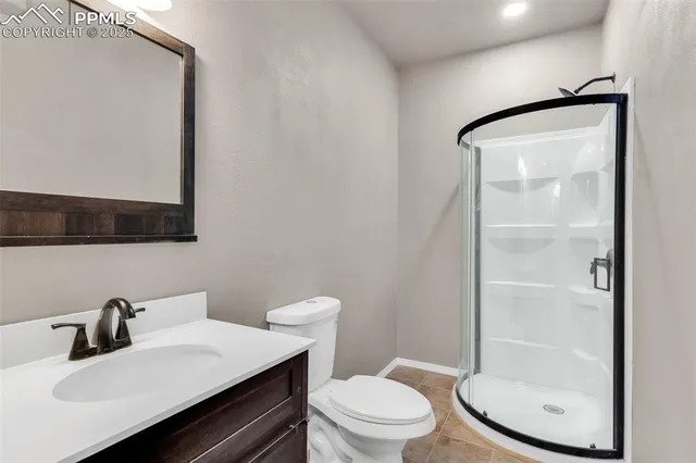 a bathroom with a sink vanity mirror and toilet