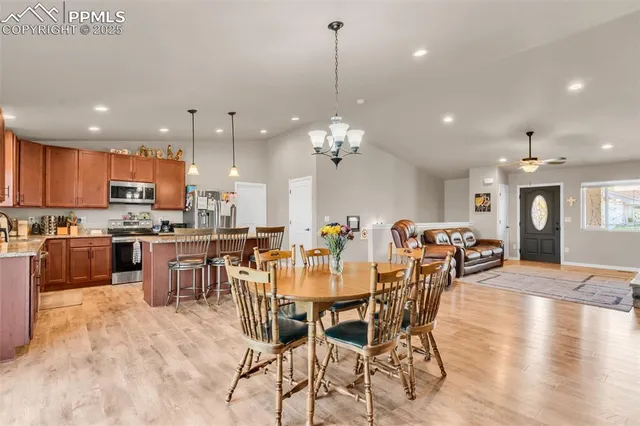 a large kitchen with a table and chairs
