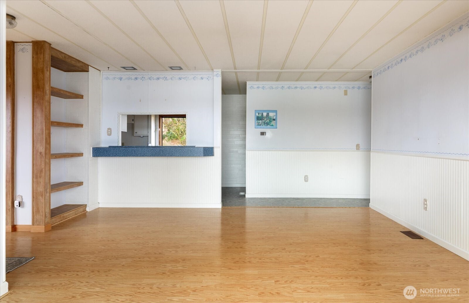 1677 Penn Cove Road Oak Harbor, WA 98277 - Photo 11 of 40 a view of a big room with wooden floor and windows