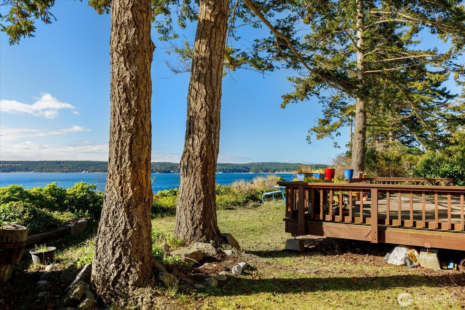 1677 Penn Cove Road Oak Harbor, WA 98277 - Photo 2 of 40 a wooden deck with a lake view
