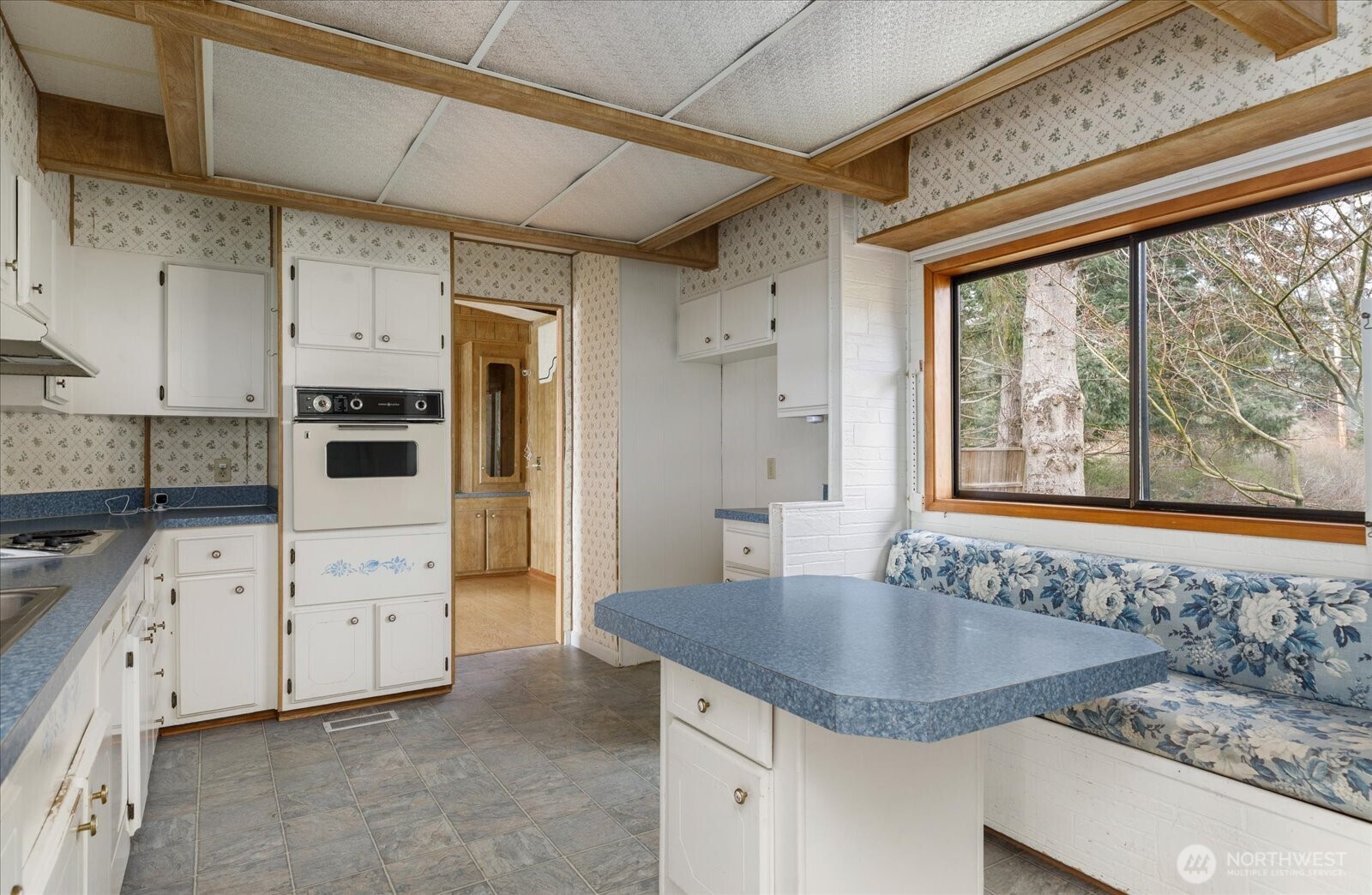 1677 Penn Cove Road Oak Harbor, WA 98277 - Photo 23 of 40 a kitchen with granite countertop a sink stainless steel appliances and cabinets