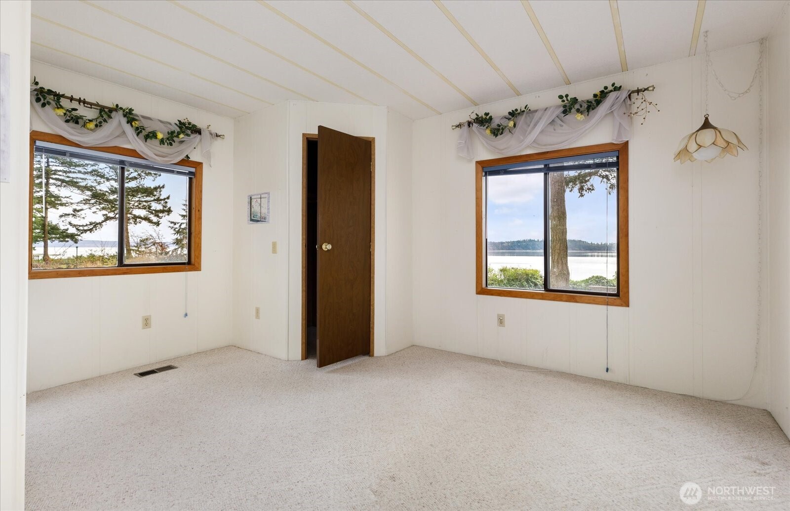 1677 Penn Cove Road Oak Harbor, WA 98277 - Photo 28 of 40 an empty room with windows and closet