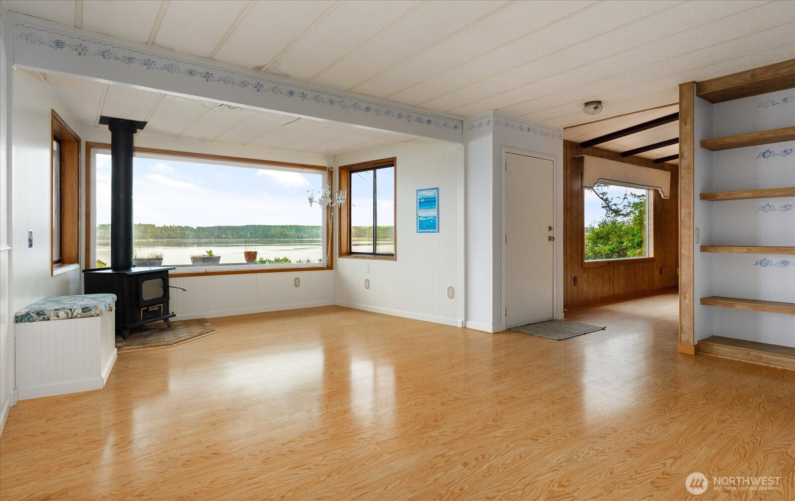 1677 Penn Cove Road Oak Harbor, WA 98277 - Photo 8 of 40 a view of an empty room with a window and wooden floor