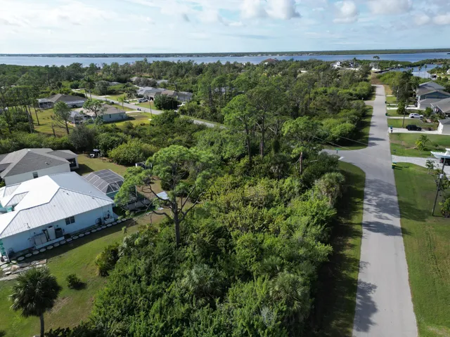 an aerial view of a houses with yard