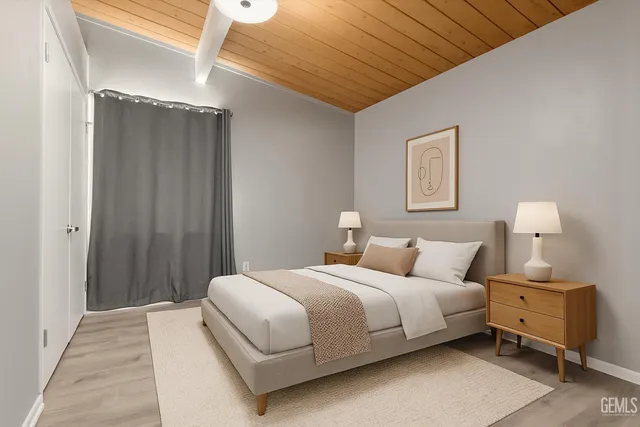 a bedroom with a bed and a night stand