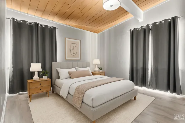 a bedroom with a bed dresser and a window