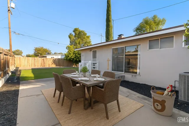 a view of a patio with a table and chairs