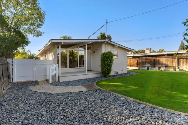 a front view of a house with a garden