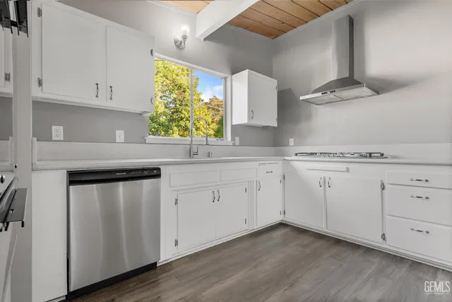 a kitchen with stainless steel appliances white cabinets and a sink