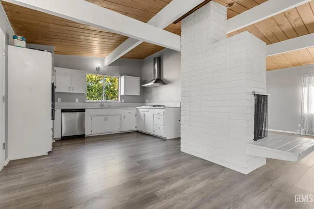 a kitchen with cabinets wooden floor and a sink
