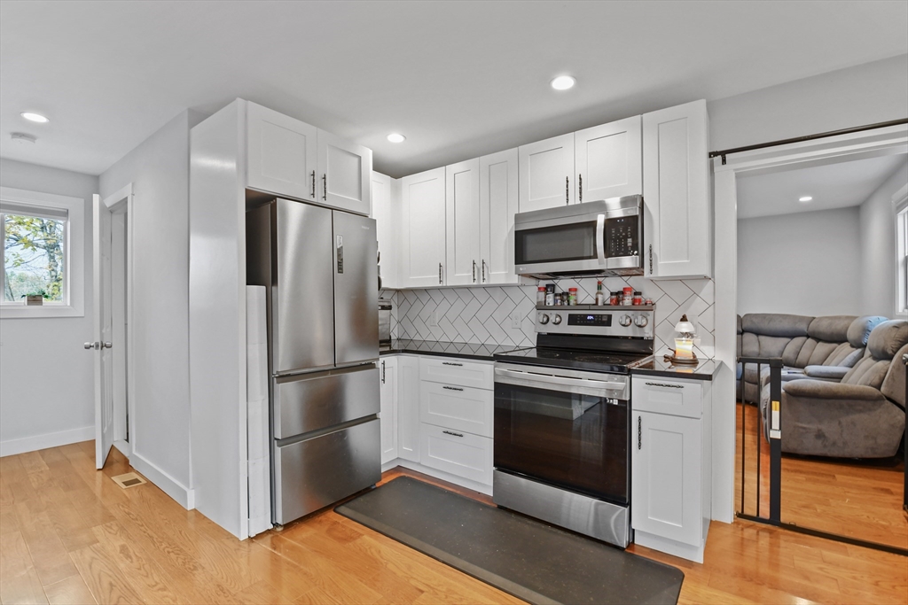 38 Twichell Street Athol, MA 01331 - Photo 11 of 26 a kitchen with a refrigerator stove and microwave