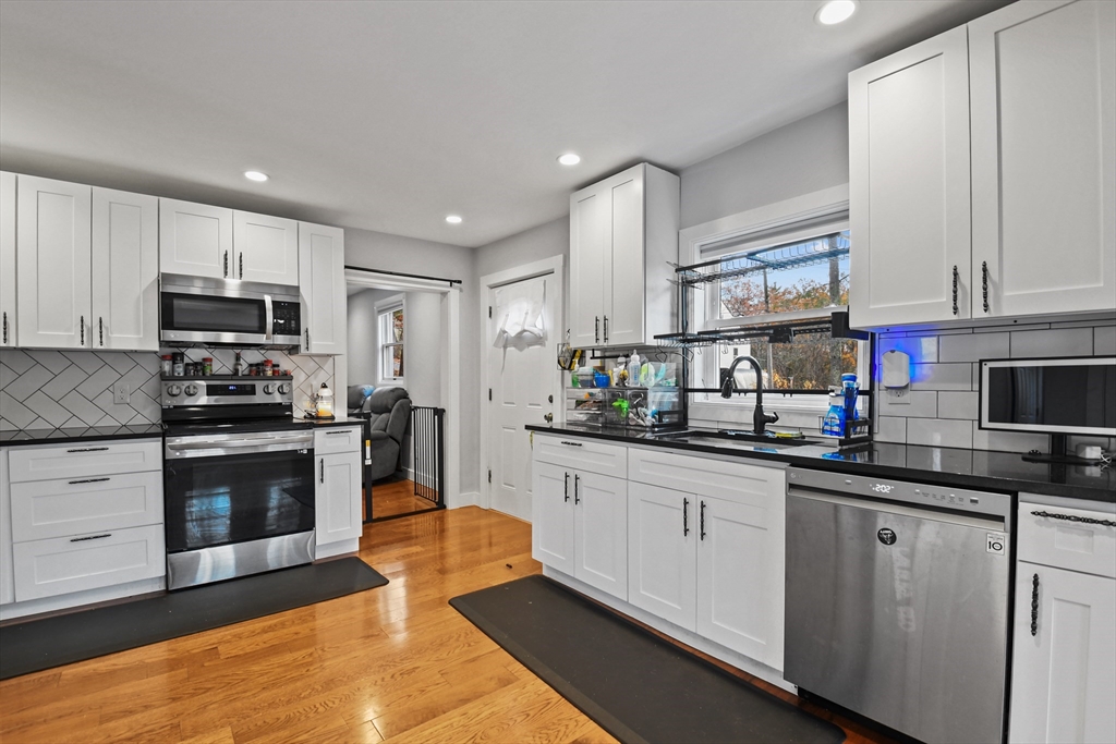 38 Twichell Street Athol, MA 01331 - Photo 10 of 26 a kitchen with stainless steel appliances granite countertop a sink a stove top oven a counter space and cabinets
