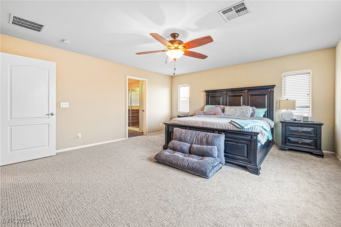 10523 Laurel Mountain Lane Las Vegas, NV 89166 - Photo 14 of 36 Primary Carpeted bedroom with baseboards and a ceiling fan